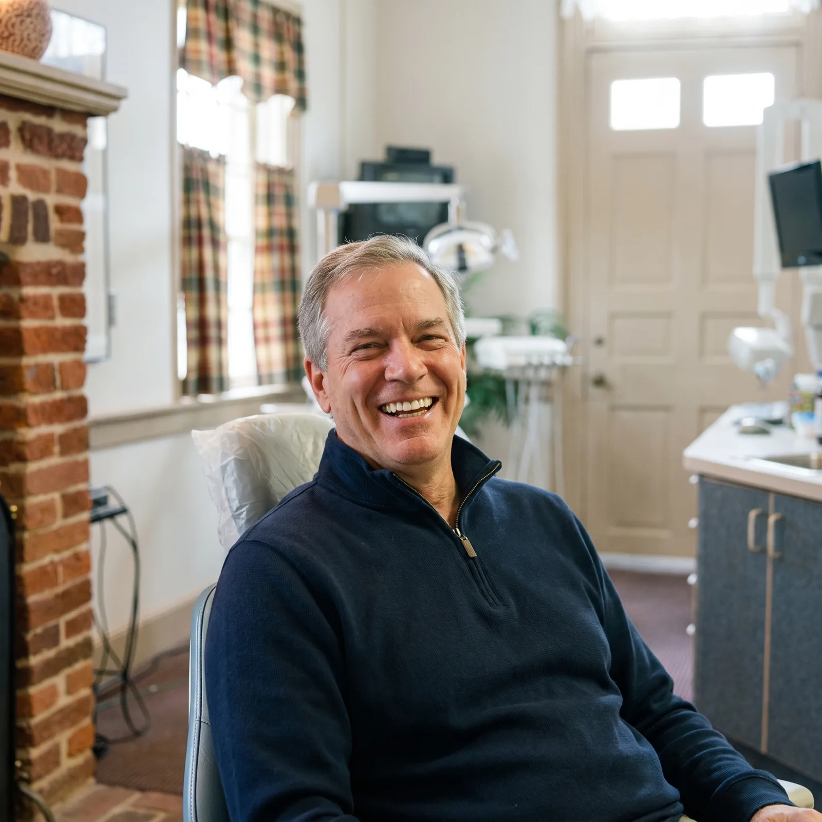 A smiling patient in a treatment room at Southern York Smile Care