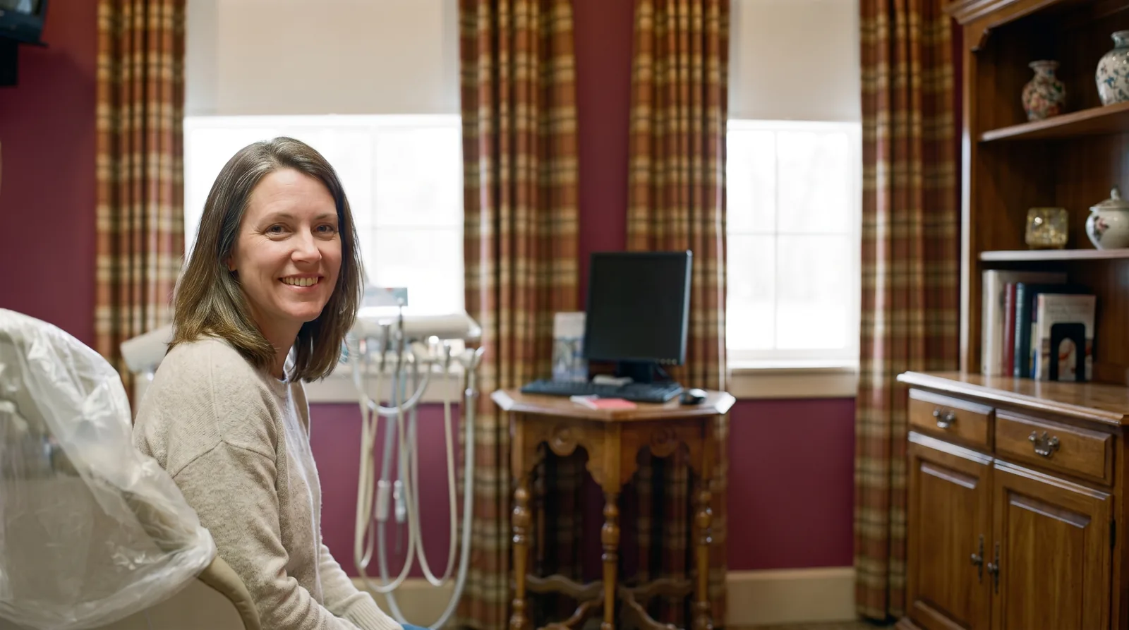 A dental implant patient smiling in the treatment chair