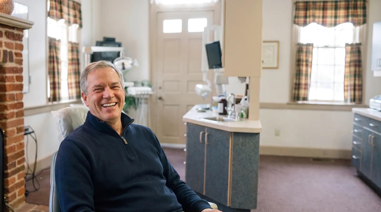 A patient smiling in a treatment room at Southern York Smile Care